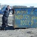Jenny stands in front of Utqiagvik dumpster.